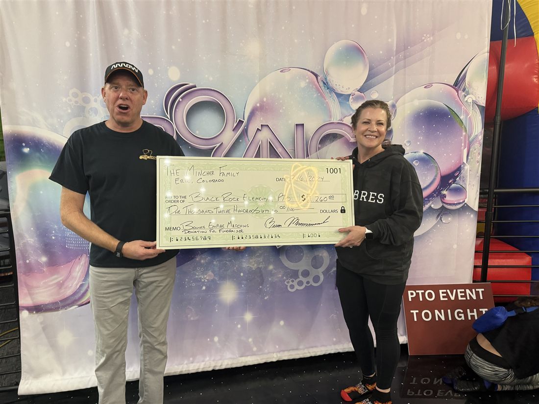 A giant check being presented at a Bounce Empire PTO fundraiser night